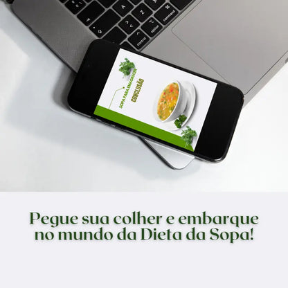 Celular sobre um notebook onde mostra a  conclusão do e-book sopa para emagrecer - um guia para iniciantes dizendo para pegar sua colher e embarcar no mundo da Dieta da sopa!