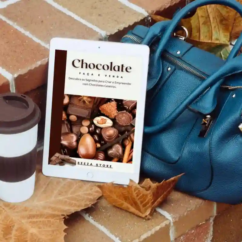 ebook chocolate faça e venda no tablet ao lado de uma bolsa e um copo